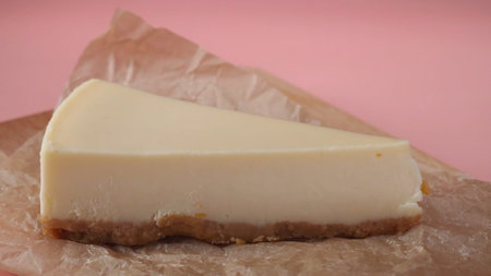 Delicious slice of cheesecake, which is pouring by thin stream of caramel sauce. Frame. Close-upの写真素材