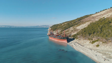 View on large red tanker ship in the sea near the shore. Shot. View from aboveの写真素材