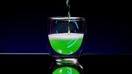 Bright art shooting . Stock Clip . An illuminated purple background that changes color and standing bright alcohol with lemon and fir branches .の写真素材