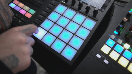 Click colored squares on mixer panel. ART. Hands in dark room are dialing code from multi-colored...