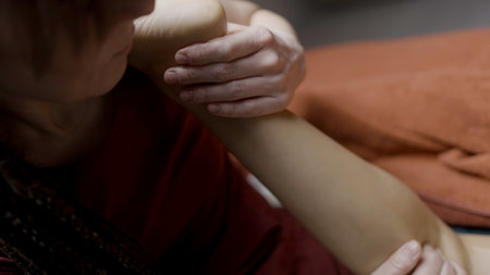 Woman therapist massaging and renewable female leg muscles. Action. Female hands giving leg and calf massageの写真素材