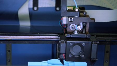Close-up of moving machine in 3d printer. Media. Creating objects on 3D printer with machine....