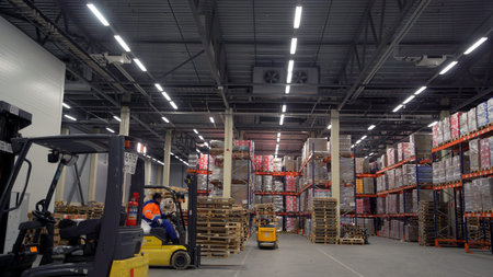 Moscow - Russia, 04.20.2022: Forklift truck moving between large metal shelves at a modern warehouse...