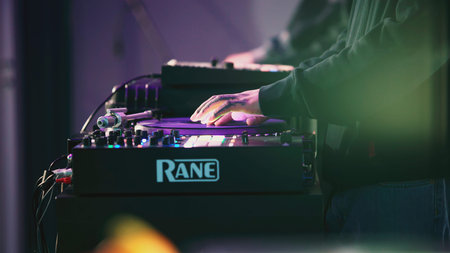 UNITED ARAB EMIRATES, ABU DHABI - MARCH 17, 2022: Two DJs are mixing music on console. Art. People...