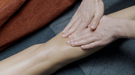 Close up of professional leg massage at the spa salon. Action. Relaxing procedure, concept of healthcare.の写真素材