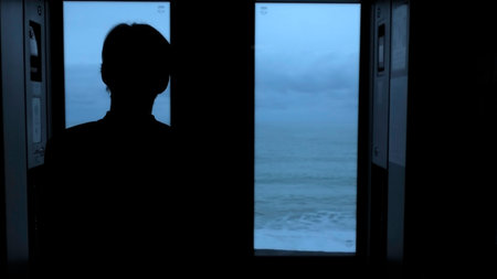 Man traveling by train and looking through the window at the sea. Stock clip. Beautiful late evening seascape from the moving train.の写真素材