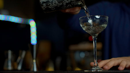 A professional bartender preparing an alcoholic cocktail. Media. Making a beverage at the bar or disco club.の写真素材