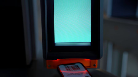 Close up of electronic turnstile with plastic card entering system. Media. Using smartphone with barcode, access control equipment.の写真素材