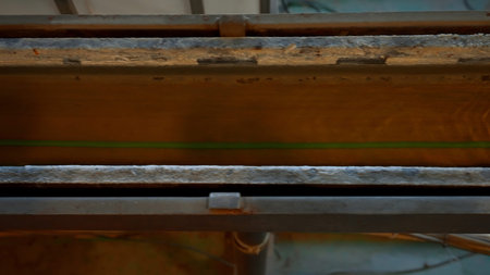 Close up top view of long opened pipe with a stretching wire inside flowing solution. Creative. Industrial background, interior details of a plant.の写真素材