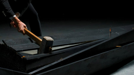 Man breaks wooden box. Stock footage. Emotional theatrical scene of destruction of coffin. Man in...