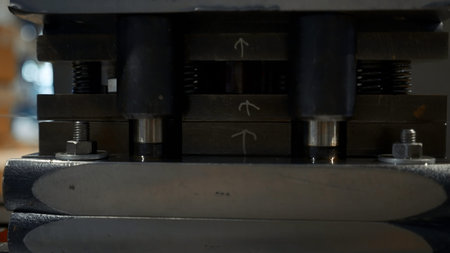 A large industrial punch press forming sheet metal parts. Creative. Close up of sheet metal stamping...