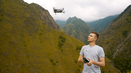 Man launches drone in mountains. Action. Man launches drone for professional shooting of mountain...