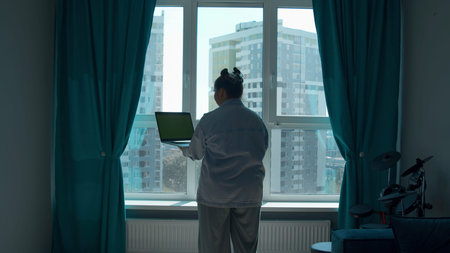 Young woman working from home, concept of freelance or remote work. Media. Woman with a laptop with...