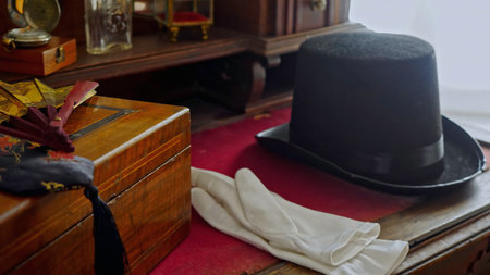 Close up of vintage table with jewelry box, top hat, and white gloves. Stock footage. Retro style background.の写真素材