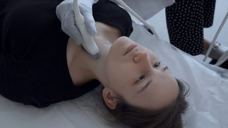 Young woman has throat ultrasound. Clip. Teenager has ultrasound of neck and throat to check glands....
