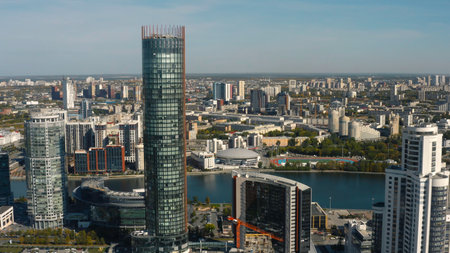 Top view of beautiful city with skyscrapers on horizon background. Stock footage. Beautiful city with skyscrapers and river on summer day. Summer landscape of modern city with high-rise buildings and green landscapesの写真素材