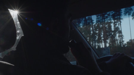 Man drives car and smokes. Media. Man is driving in car and smoking Iqos. Man smoking modern...