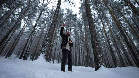 Man raps in winter forest. Media. Stylish man moves in hip hop style in winter forest. Man reads hip...