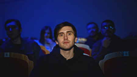 Young man is watching theatrical performance. Media. Man is watching theatrical performance in...
