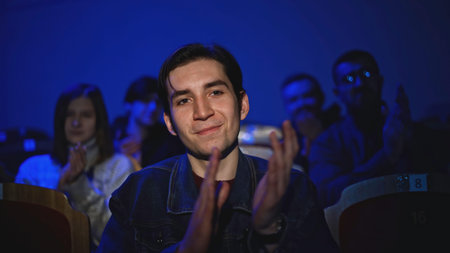 Young man is watching theatrical performance. Media. Man is watching theatrical performance in...