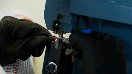 Close up of engineer soldering wires at the factory. Creative. Using professional equipment.