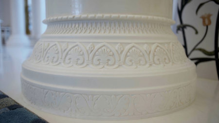 Close up of white beautiful pillar with carved pattern. Scene. Interior details of a white mosque.