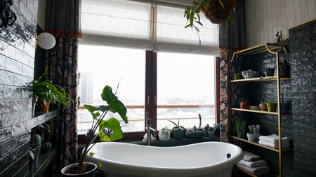 Modern contemporary dark bathroom with natural light and many green plants. Creative. Cozy apartment...
