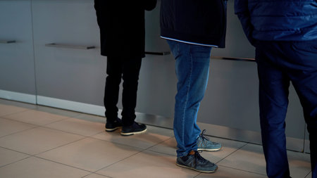 People staying by the glass information desk at a hospital or business center. Media. Reception desk...