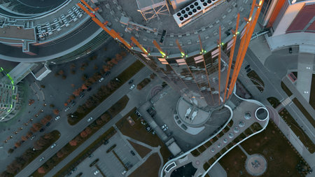 Top view of colorful glowing high-rise on summer day. Stock footage. Beautiful facade of luminous...