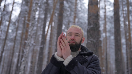Man in a cold snowy forestの写真素材