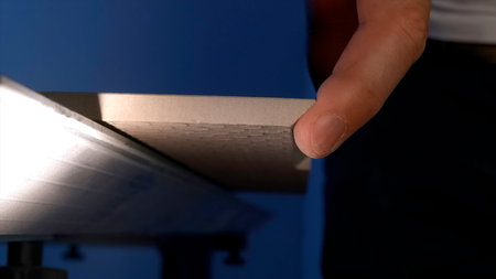 Carpenter worker on work table cuts a wooden plank with a circular saw. manual work. Creative. Construction and carpentry concept.の写真素材