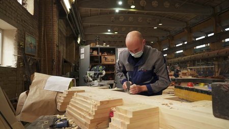 Craftsman Dedicatedly Working in a Wood Workshop, Showcasing Their Expertise in Craftsmanship. Stock...