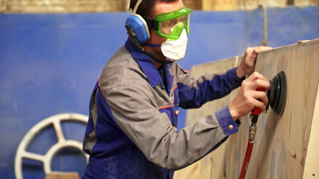 A skilled professional craftsman expertly utilizing various power tools for woodworking tasks. Stock Clipの写真素材