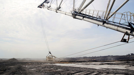 Massive Excavation Machinery Engaged in Work Within an Expansive Industrial Landscape Setting. Stock Clipの写真素材