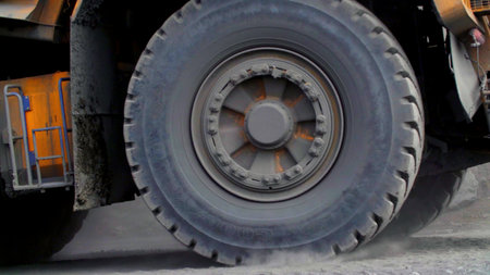 A Heavy Duty Truck Tire in Action Performing on a Construction Site with Multiple Activities. Stock Clipの写真素材