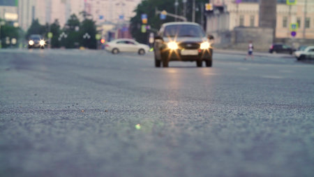 A city road bustling with cars at dusk, creating a beautiful scene of urban life. Stock Clipの写真素材