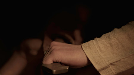 Close up of man taking big, sharp sword. Media. Armor for knights of medieval times.の写真素材