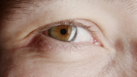 Macro shot opening and closing green and brown eye, middle aged man. Close up motion of male eye.