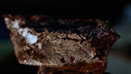 Close up of glossy stone mineral on a blurred background. Stock footage. Natural resources concept.