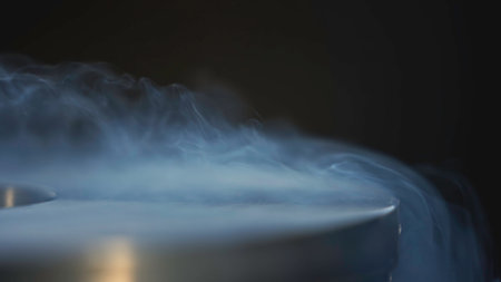 Beautiful steam moving out of container. Stock footage. Metal container with steam escaping from hot water. Hot steam moves in beautiful stream from panの写真素材