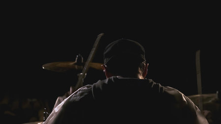 Close-up of playing drums. Clip. Man plays drums at night festival. Night performance of playing drumsの写真素材