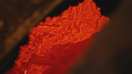 Molten metal freezes. Stock footage. Close-up of solidifying stream of molten metal. Molten metal cools and hardens at metallurgical plantの写真素材