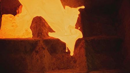 Close-up of flowing streams of molten metal. Stock footage. Molten jets of current metal flow. Metallurgical plant with molten metal streamsの写真素材