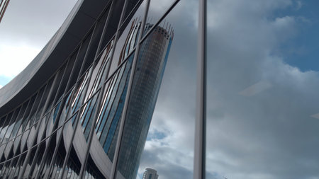 Reflection of high-rise in glass building. Stock footage. Beautiful modern architecture of glass...
