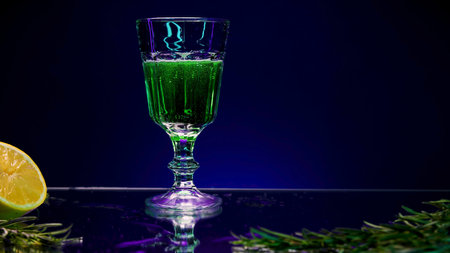 Close-up of glass of green drink. Stock clip. Refreshing drink in glass on colored stone. Drink with ingredients.の写真素材