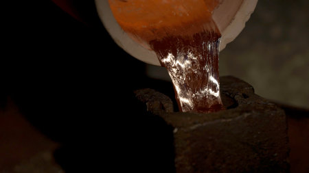 Shaping molten metal. Steel Factory. Liquid iron flowing in steelworks. Industrial details of metallurgic factory or plant. Details of smelting metalの写真素材