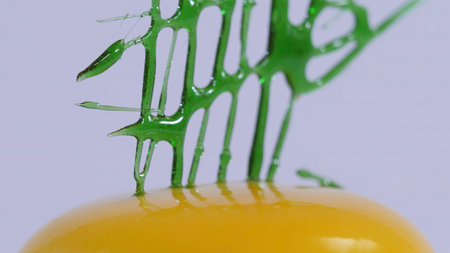 Modern mousse cakes with caramel glaze decorated for kids party. Yellow Mousse Cake decorated with green caramel close upの写真素材