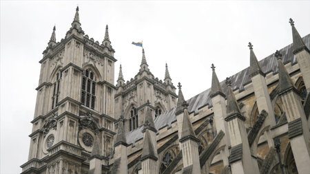 View from the bottom on the Westminster Abbey exterior details against the grey cloudy sky. Action....