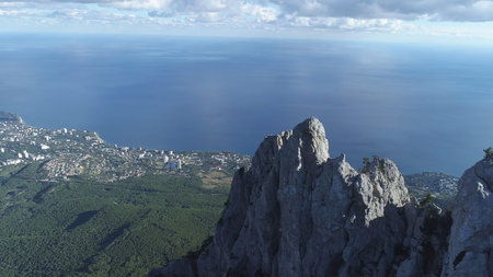 Gorgeous scenery of the blue sea and small city on the shore against beautiful white cliff and...