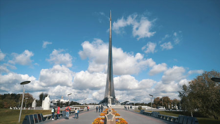 Close-up of people walking near the monument in memory of achievements of the Soviet people in space...